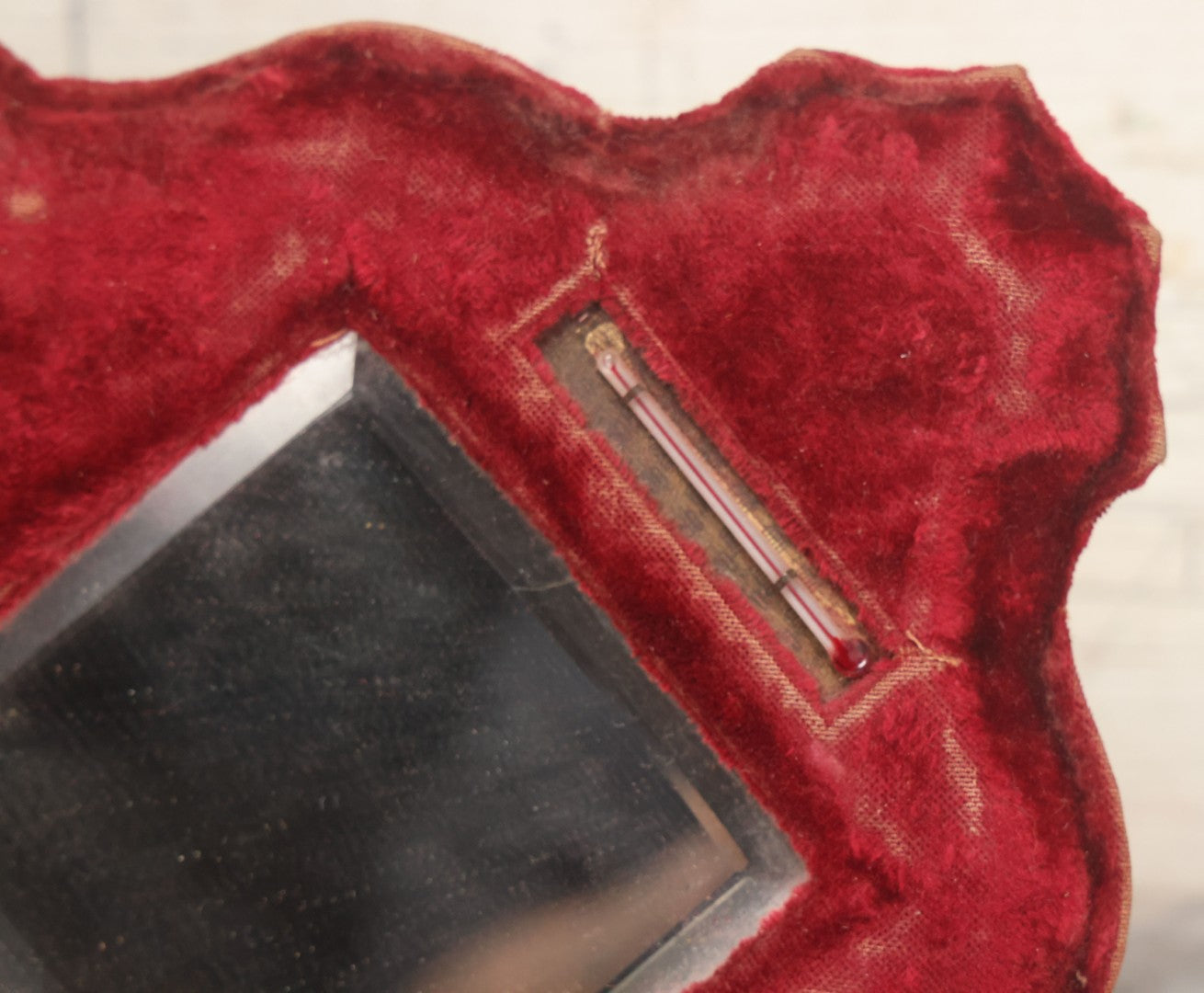 Lot 104 - Antique Beveled Dresser Mirror With Red Velvet Surround And Thermometer, Pressboard Backing, And Wire Kick Stand