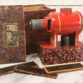 Lot 005 - Antique Magic Lantern Projector In Original Box With Eleven Slides, On Base With Storage Compartment, Original Paper Label Instructions, By Ernst Plank Company, Nuremberg, Germany, Note Missing Metal Chimney