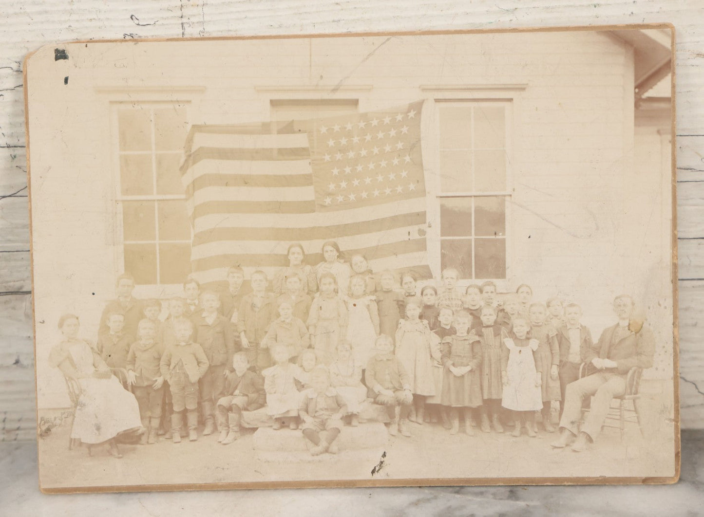 Lot 112 - Antique Boarded Photograph Of Western Pennsylvania School Class Posing In Front Of 44 Star American Flag With Teachers, Lenning & Thompson, Photographers, Martinsburg, Pennsylvania