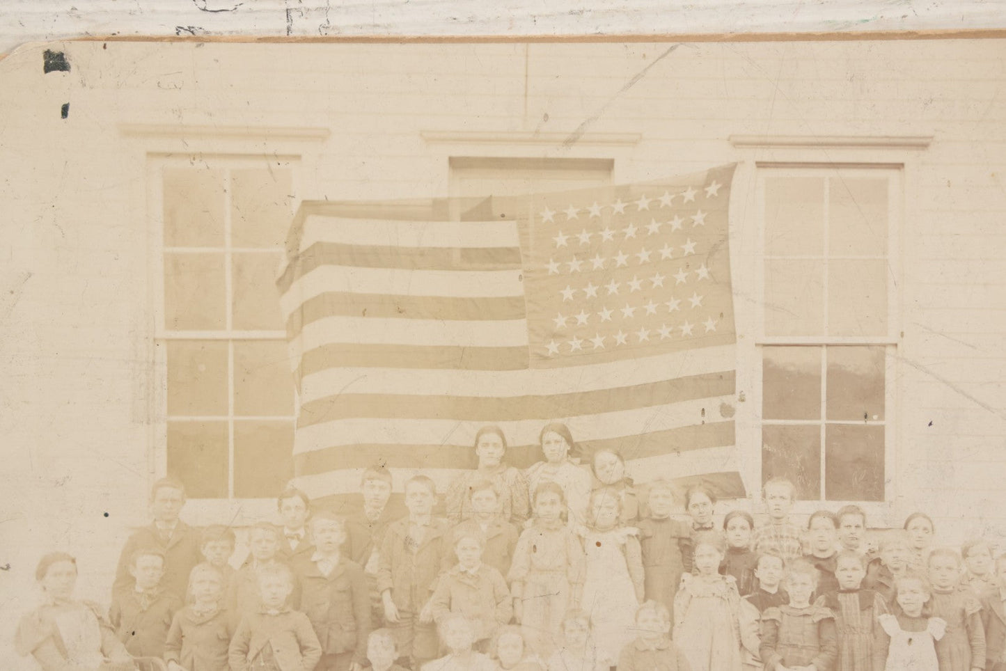 Lot 112 - Antique Boarded Photograph Of Western Pennsylvania School Class Posing In Front Of 44 Star American Flag With Teachers, Lenning & Thompson, Photographers, Martinsburg, Pennsylvania
