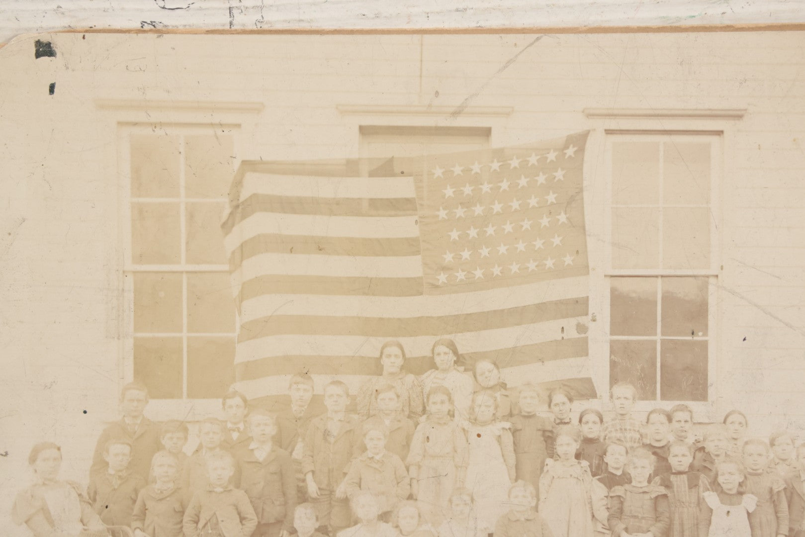 Lot 112 - Antique Boarded Photograph Of Western Pennsylvania School Class Posing In Front Of 44 Star American Flag With Teachers, Lenning & Thompson, Photographers, Martinsburg, Pennsylvania