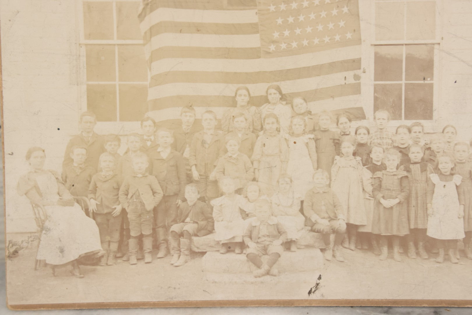 Lot 112 - Antique Boarded Photograph Of Western Pennsylvania School Class Posing In Front Of 44 Star American Flag With Teachers, Lenning & Thompson, Photographers, Martinsburg, Pennsylvania