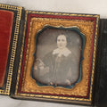 Lot 115 - Antique 1/6th Plate Daguerreotype Photograph Of Young Woman Wearing Black Lace Gloves And Large Brooch In Leatherette Folder Case With Latch, "Bijou" Lettering On Spine, Identified As Anna Matilda Blackledge, Note Partial Tear On Case Cover