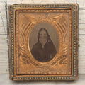 Lot 117 - Antique 1/6th Plate Ambrotype Photograph Of Solemn Woman In Dark Clothing With Patriotic Civil War Era Brass Mat With American Flags, Eagle, Cannon, "E Pluribus Unum" Banner, In Half Case