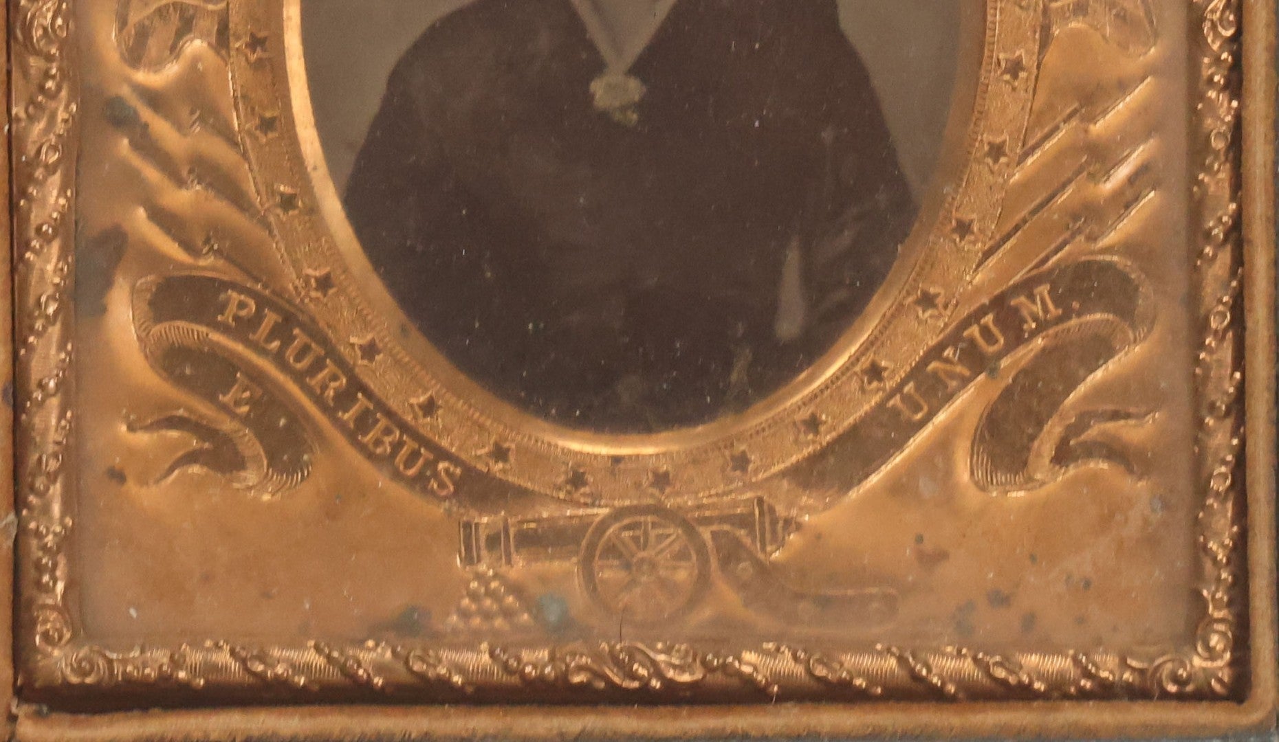 Lot 117 - Antique 1/6th Plate Ambrotype Photograph Of Solemn Woman In Dark Clothing With Patriotic Civil War Era Brass Mat With American Flags, Eagle, Cannon, "E Pluribus Unum" Banner, In Half Case
