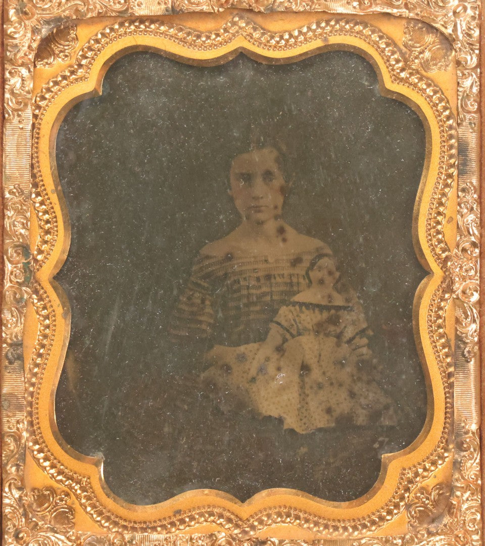 Lot 118 - Antique 1/6th Plate Ambrotype Photograph Of Young Girl In Off-The-Shoulders Dress Holding Period China Doll, Identified As Nettie L. Finch Edmonds, 1847-1936, In Full Split Leatherette Union Case