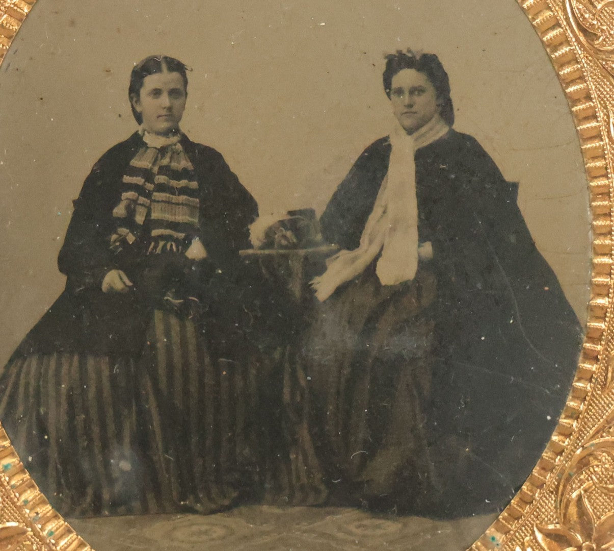 Lot 120 - Antique 1/6th Plate Tintype Photograph Of Two Ladies Seated At Table In Period Thermoplastic Frame With Hanging Hook, 4-1/8" x 4-5/8"