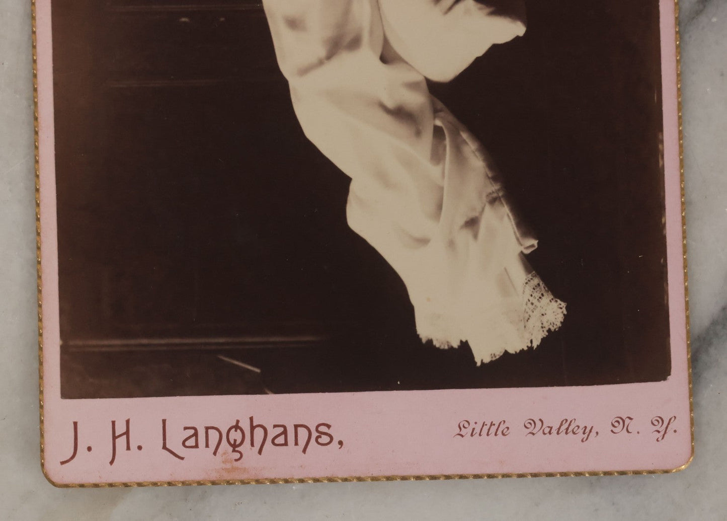 Lot 027 - Antique Cabinet Card Postmortem Photograph Of Baby Laying On Pillows With Dark Background, J.H. Langhans, Photographer, Little Valley, New York