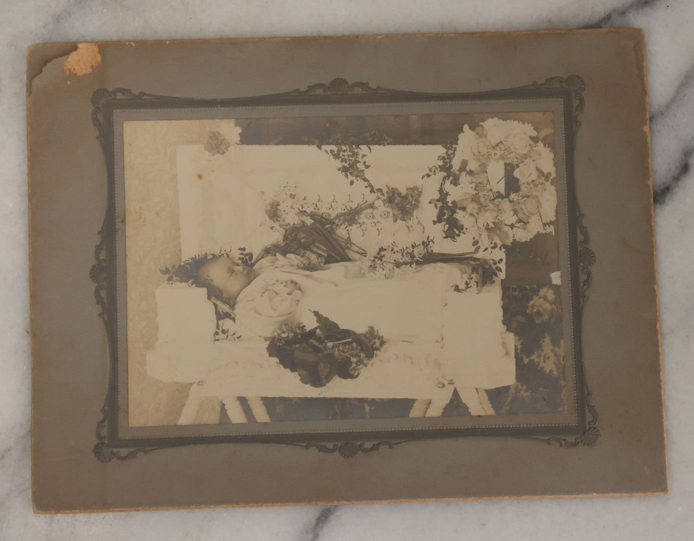 Lot 029 - Antique Boarded Post Mortem Photograph Of Baby In White Childs Coffin With Flowers