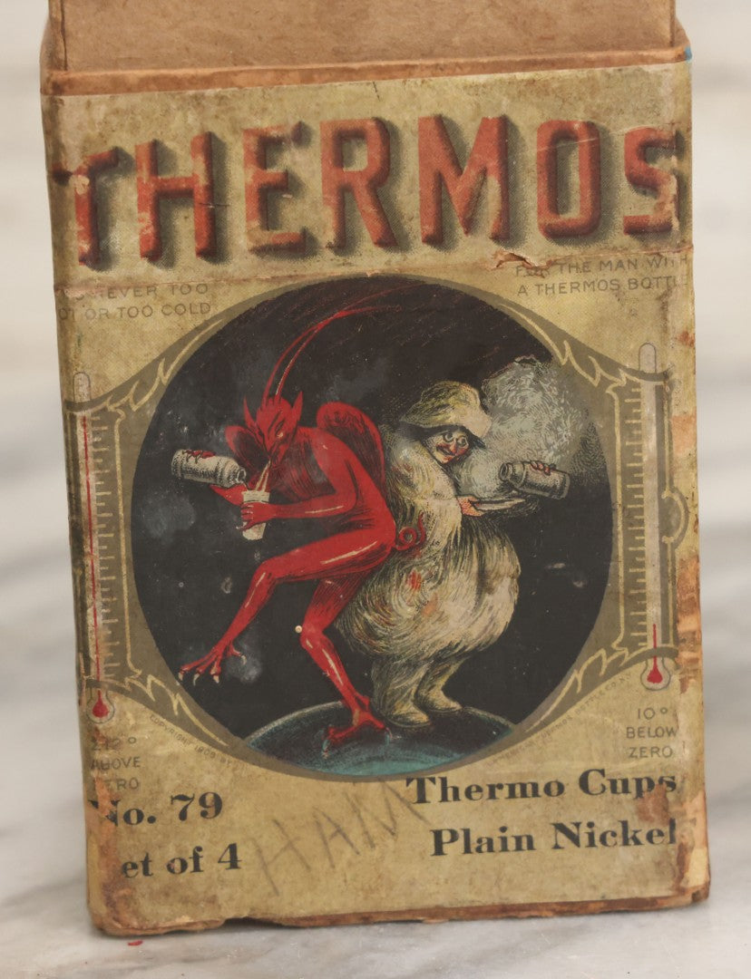Lot 048 - Antique Thermos Brand Thermo Cup Set Of Four Plain Nickel Cups No. 79, With Original Box With Devil Graphics, Manufactured By The American Thermos Bottle Co., New York, Patented 1912, Complete Set
