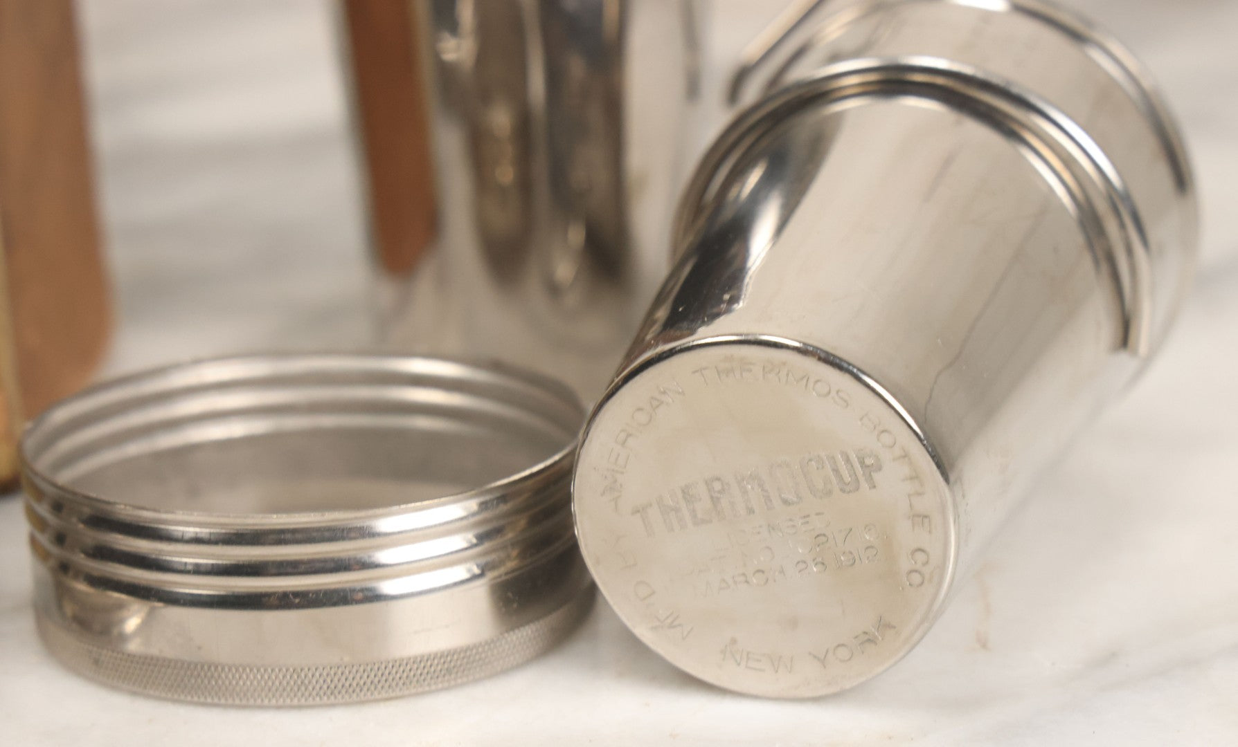 Lot 048 - Antique Thermos Brand Thermo Cup Set Of Four Plain Nickel Cups No. 79, With Original Box With Devil Graphics, Manufactured By The American Thermos Bottle Co., New York, Patented 1912, Complete Set