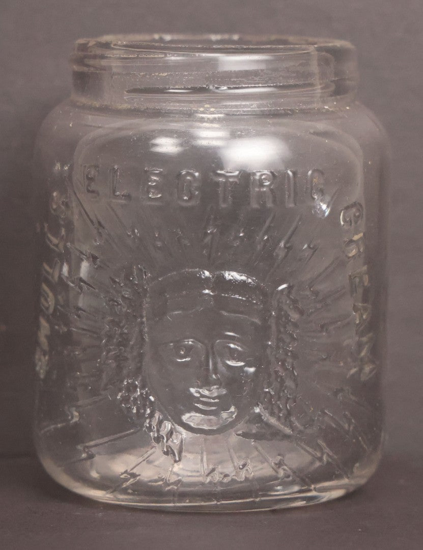 Lot 050 - Antique "Shull's Electric Cream" Patent Medicine Glass Jar Bottle With Face With Lightning Bolts Embossed Graphics, W.S. Monogram On Bottom, Note Chip On Rim