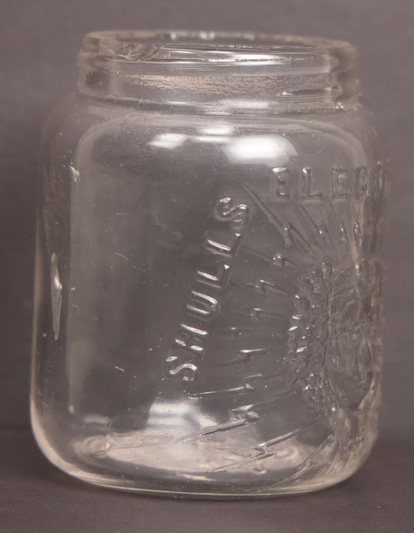 Lot 050 - Antique "Shull's Electric Cream" Patent Medicine Glass Jar Bottle With Face With Lightning Bolts Embossed Graphics, W.S. Monogram On Bottom, Note Chip On Rim