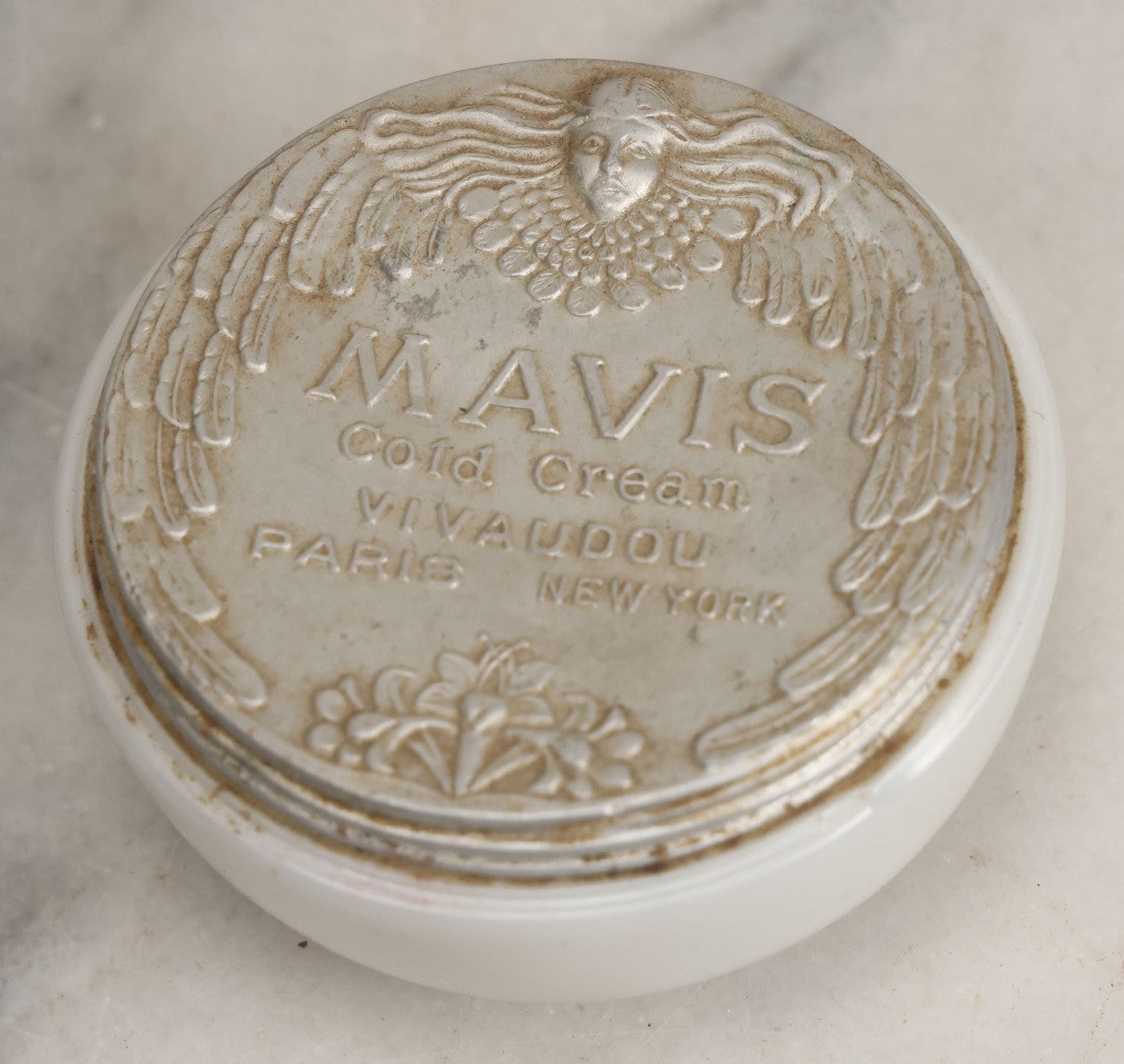 Lot 052 - Vintage Mavis Cold Cream Vivaudou Milk Glass Jar With Metal Art Deco Lid With Winged Woman Head, Paris And New York