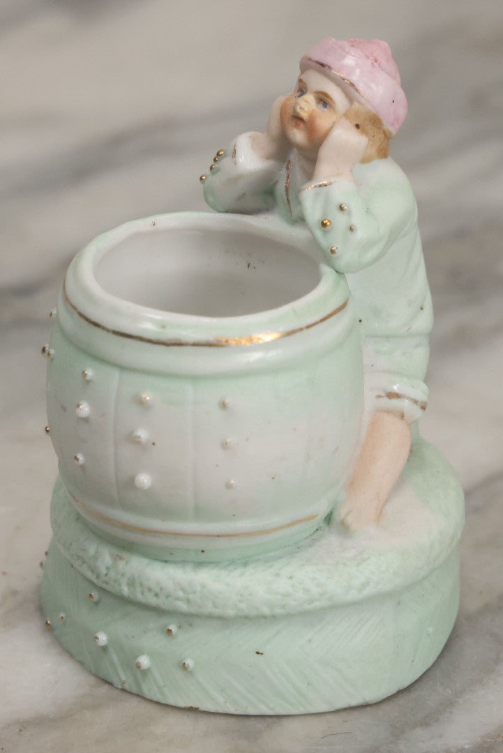 Lot 062 - Antique Bisque Toothpick Holder With Little Boy In Pink Hat Leaning On Barrel, Likely Made In Germany, Marked No. 2359