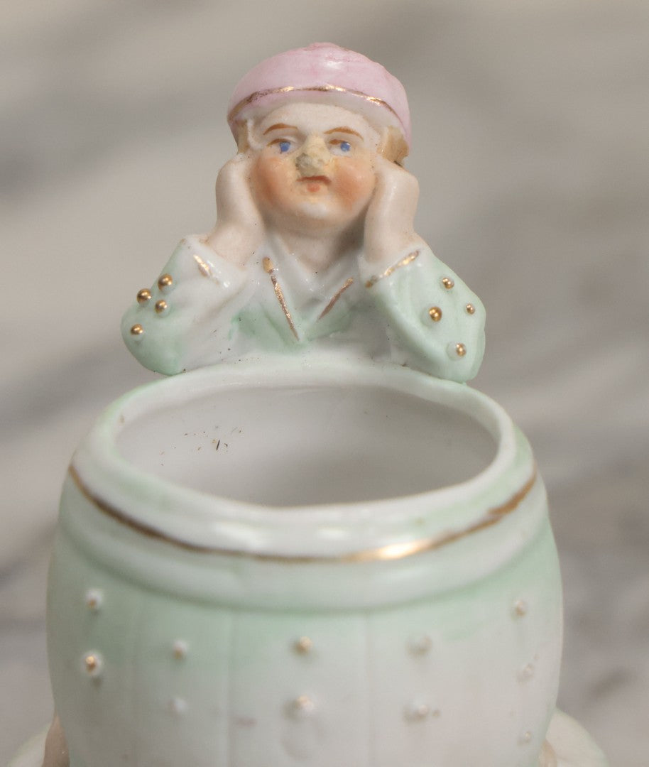 Lot 062 - Antique Bisque Toothpick Holder With Little Boy In Pink Hat Leaning On Barrel, Likely Made In Germany, Marked No. 2359
