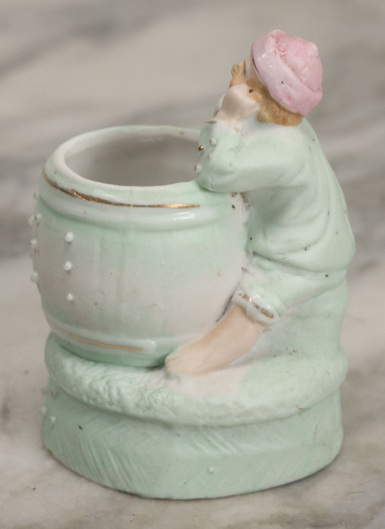 Lot 062 - Antique Bisque Toothpick Holder With Little Boy In Pink Hat Leaning On Barrel, Likely Made In Germany, Marked No. 2359