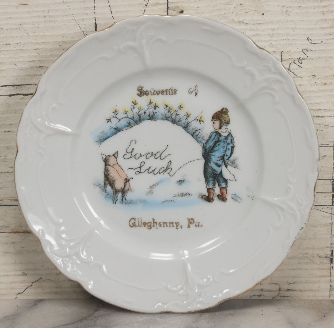 Lot 063 - Antique Porcelain Plate With Boy Peeing "Good Luck" Message In Snow With His Pet Pig, Souvenir Of Gileghenny, Pennsylvania, Made In Germany, No. 281, 6-3/8" Diameter