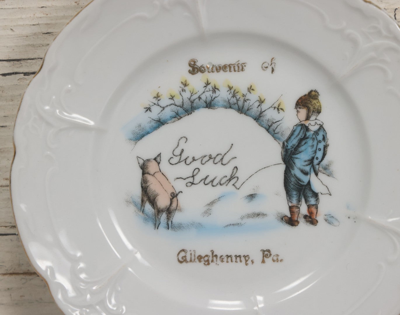 Lot 063 - Antique Porcelain Plate With Boy Peeing "Good Luck" Message In Snow With His Pet Pig, Souvenir Of Gileghenny, Pennsylvania, Made In Germany, No. 281, 6-3/8" Diameter