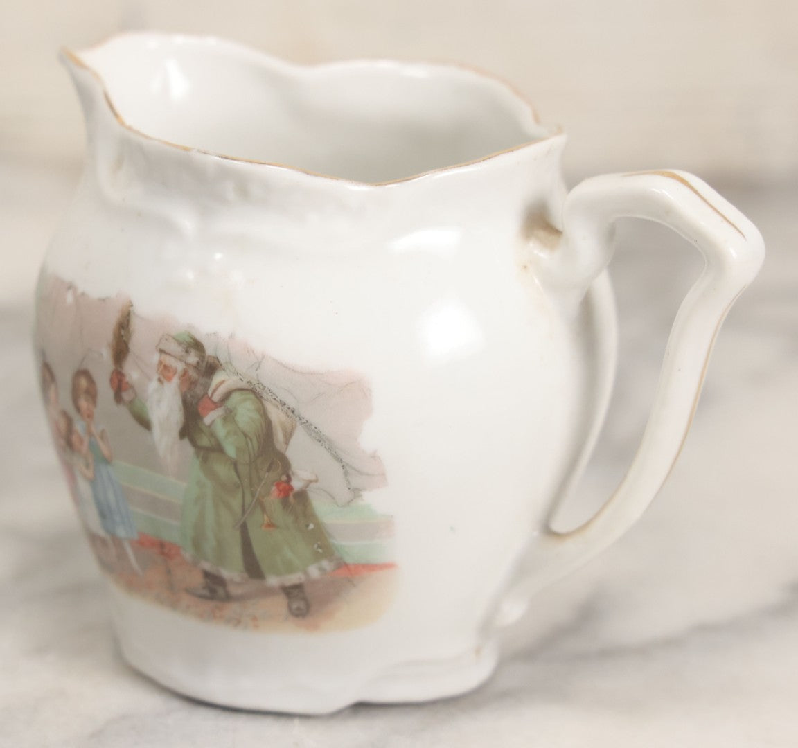 Lot 065 - Antique Porcelain Cream Pitcher With Christmas Theme, Santa Claus In Green Greeting Children With Presents, Likely Made In Germany, Unmarked