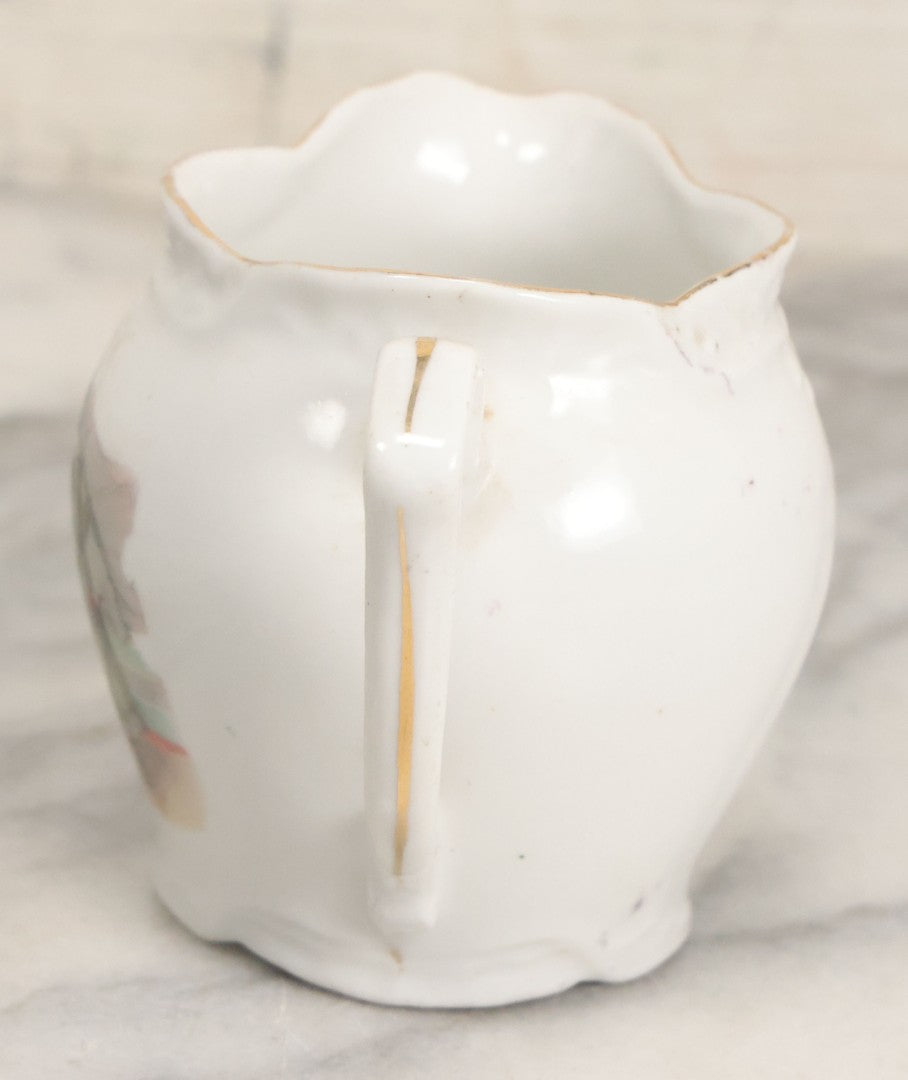 Lot 065 - Antique Porcelain Cream Pitcher With Christmas Theme, Santa Claus In Green Greeting Children With Presents, Likely Made In Germany, Unmarked