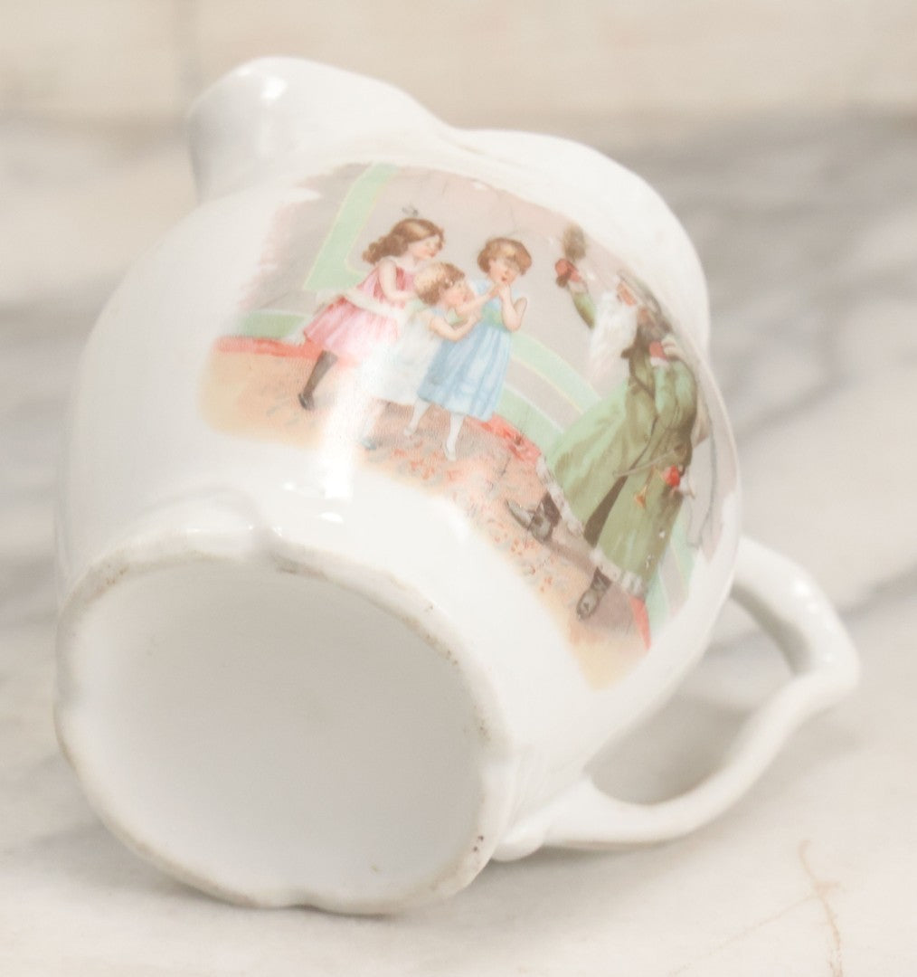 Lot 065 - Antique Porcelain Cream Pitcher With Christmas Theme, Santa Claus In Green Greeting Children With Presents, Likely Made In Germany, Unmarked