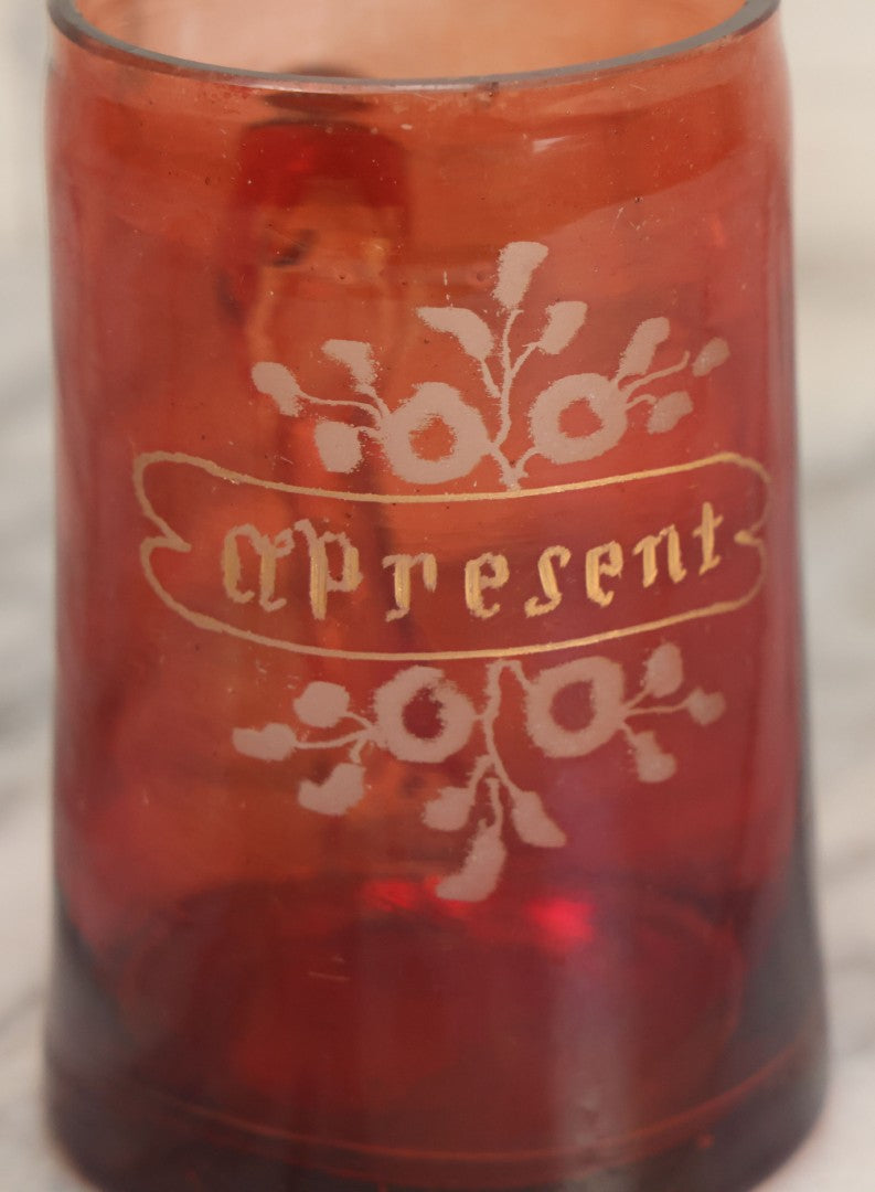 Lot 066 - Antique Ruby Glass Mug With Hand Etched, Hand Painted Details, "A Present" With Flowers, Note Chip To Bottom Of Handle, Rim