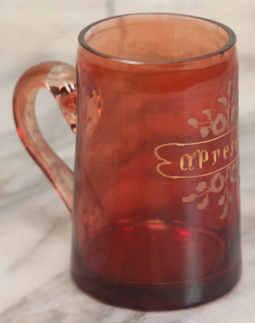 Lot 066 - Antique Ruby Glass Mug With Hand Etched, Hand Painted Details, "A Present" With Flowers, Note Chip To Bottom Of Handle, Rim