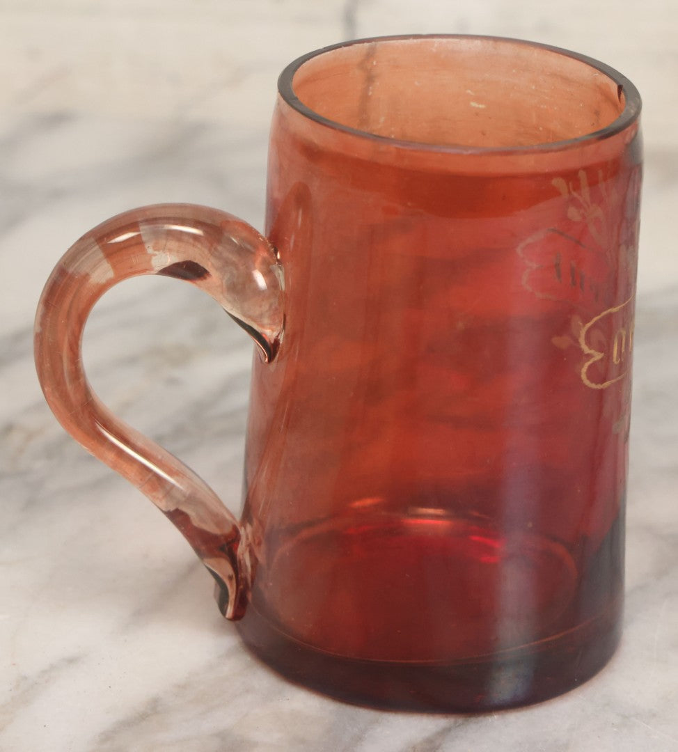 Lot 066 - Antique Ruby Glass Mug With Hand Etched, Hand Painted Details, "A Present" With Flowers, Note Chip To Bottom Of Handle, Rim
