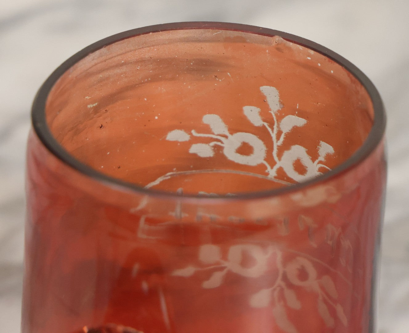 Lot 066 - Antique Ruby Glass Mug With Hand Etched, Hand Painted Details, "A Present" With Flowers, Note Chip To Bottom Of Handle, Rim