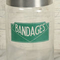 Lot 071 - Vintage Medical Doctors Office Bandages Glass Jar With Green Label And Lid, Manufactured By Profex, U.S.A.