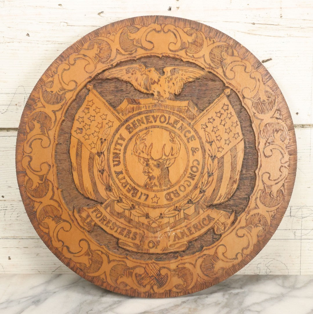 Lot 076 - Antique Wood Burned Pyrography Wall Hanging Plaque For The Foresters Of America, Fraternal Order, With Eagle And American Flags, Flemish Art Co., New York, No. 854, 14-3/4" Diameter