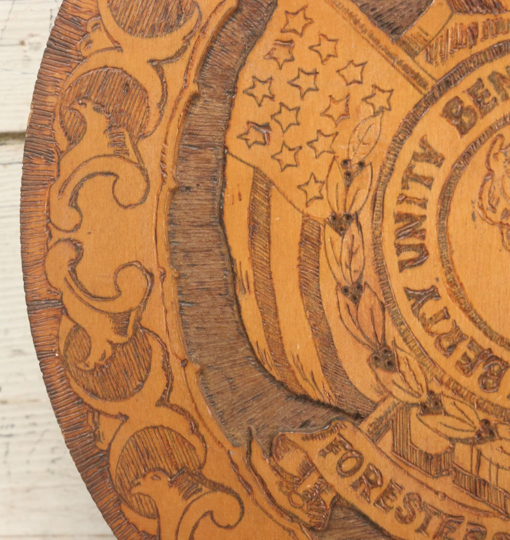 Lot 076 - Antique Wood Burned Pyrography Wall Hanging Plaque For The Foresters Of America, Fraternal Order, With Eagle And American Flags, Flemish Art Co., New York, No. 854, 14-3/4" Diameter
