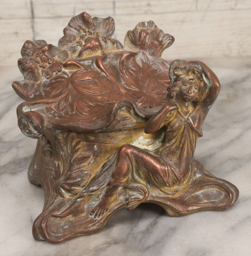 Lot 010 - Antique Art Nouveau Pot Metal Jewelry Casket With Figural Girl In Gown, Floral Motif, Tufted Red Interior, Bottom Marked M.R., Note Hinge Broken, Torn Fabric