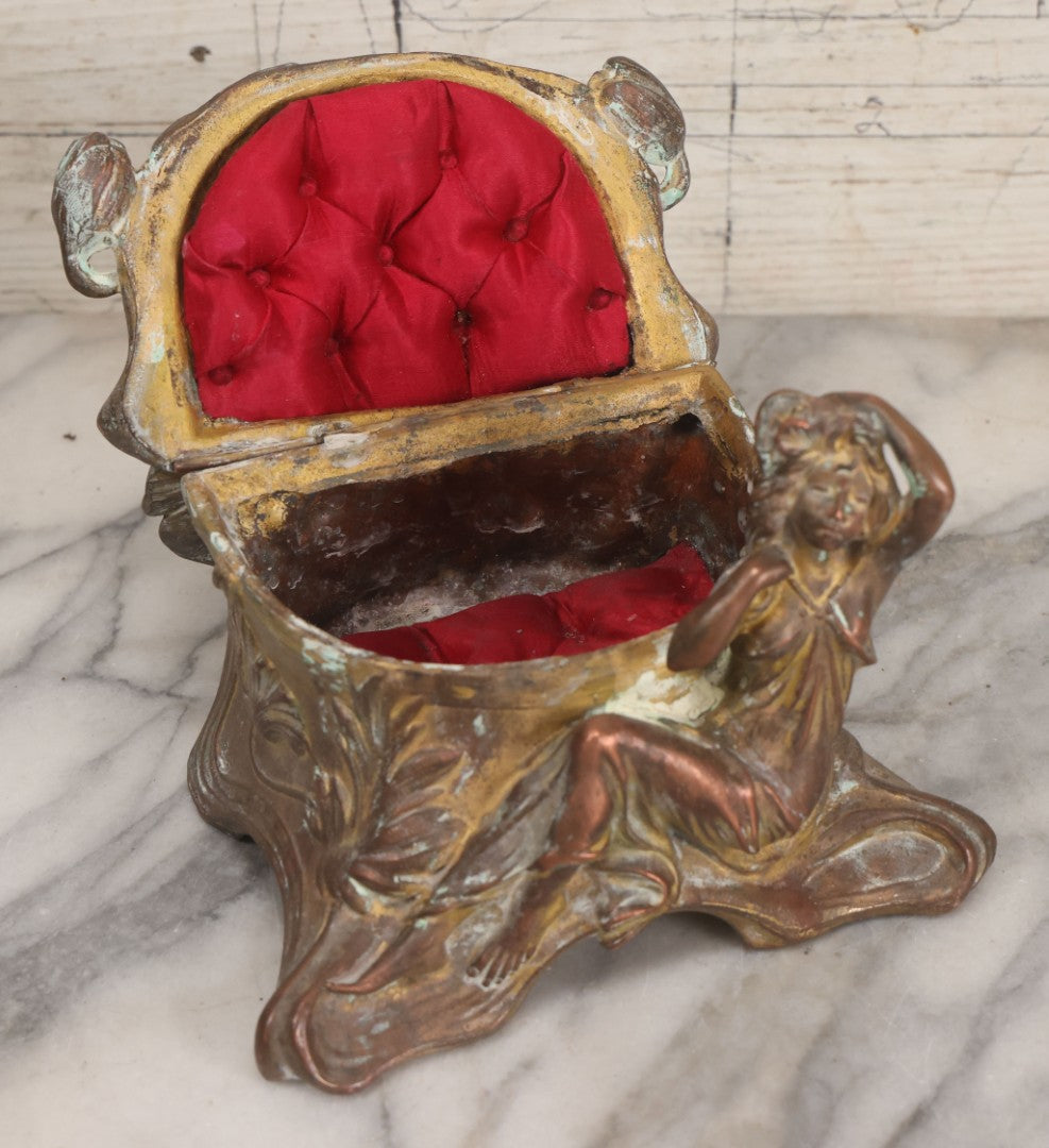 Lot 010 - Antique Art Nouveau Pot Metal Jewelry Casket With Figural Girl In Gown, Floral Motif, Tufted Red Interior, Bottom Marked M.R., Note Hinge Broken, Torn Fabric