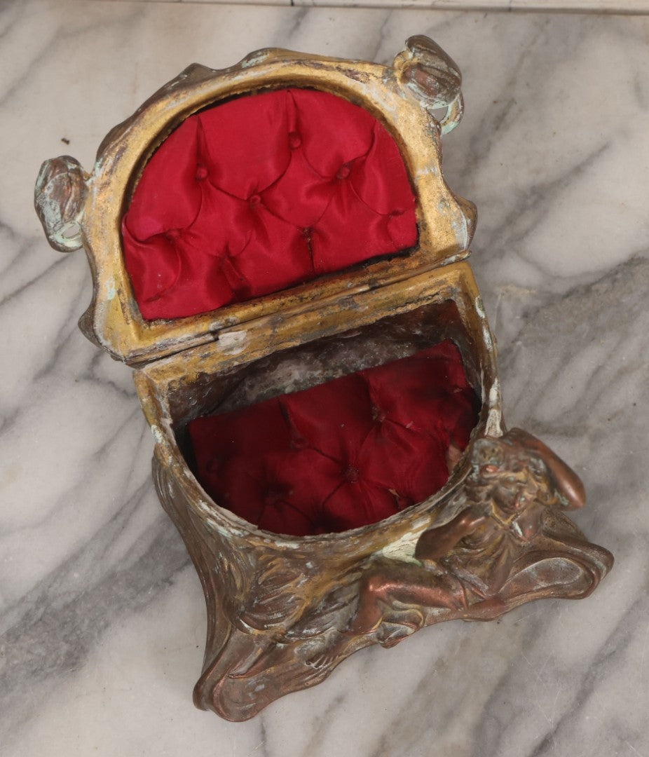 Lot 010 - Antique Art Nouveau Pot Metal Jewelry Casket With Figural Girl In Gown, Floral Motif, Tufted Red Interior, Bottom Marked M.R., Note Hinge Broken, Torn Fabric
