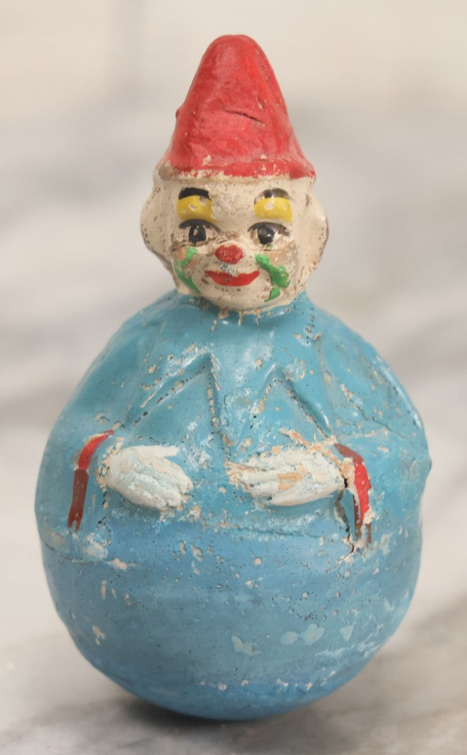 Lot 014 - Antique Papier Mache Clown Roly Poly Toy With Blue Body, Green And Yellow Makeup And Red Hat, Note Wear And Tear Throughout, Height 3-3/4"