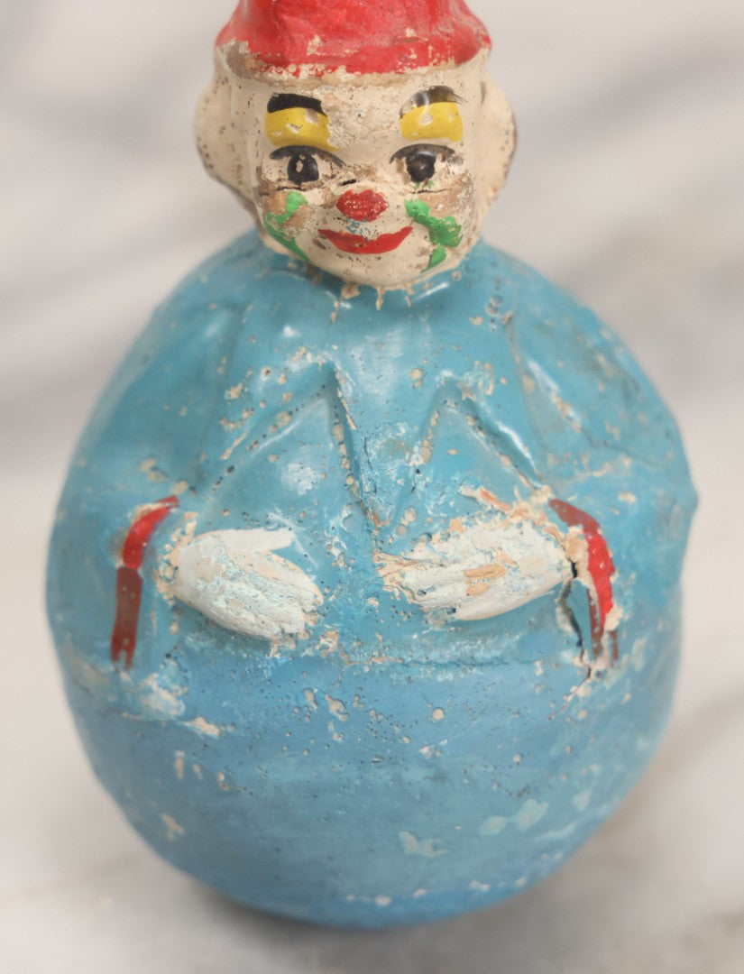 Lot 014 - Antique Papier Mache Clown Roly Poly Toy With Blue Body, Green And Yellow Makeup And Red Hat, Note Wear And Tear Throughout, Height 3-3/4"