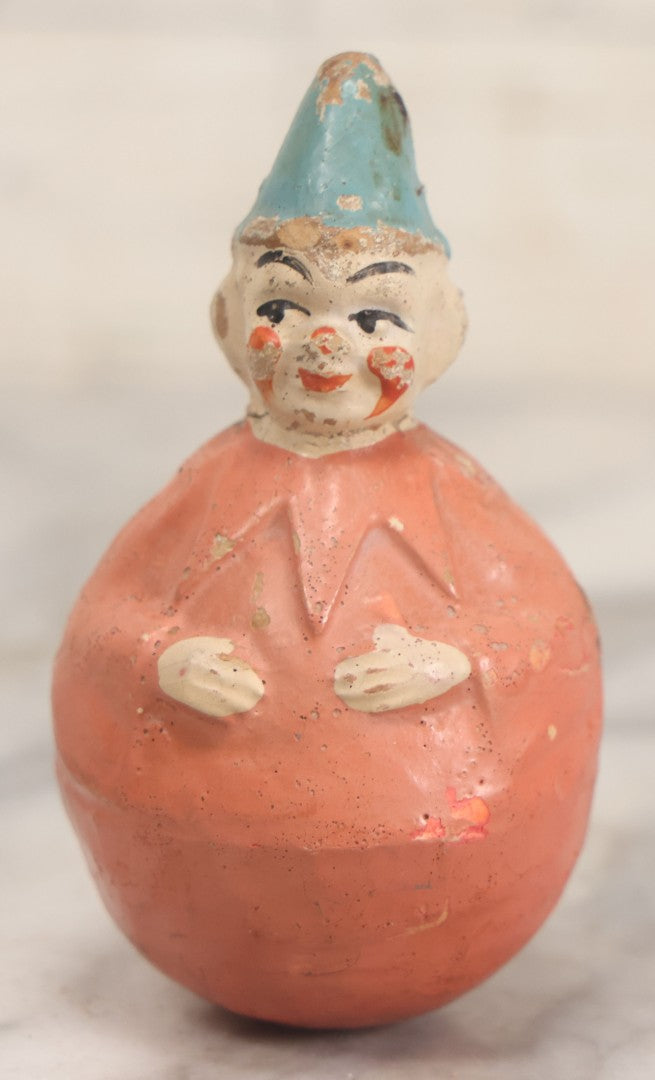 Lot 015 - Antique Papier Mache Clown Roly Poly Toy With Pink Body, Pink Makeup And Blue Hat, Note Wear And Tear Throughout, Height 3-3/4"