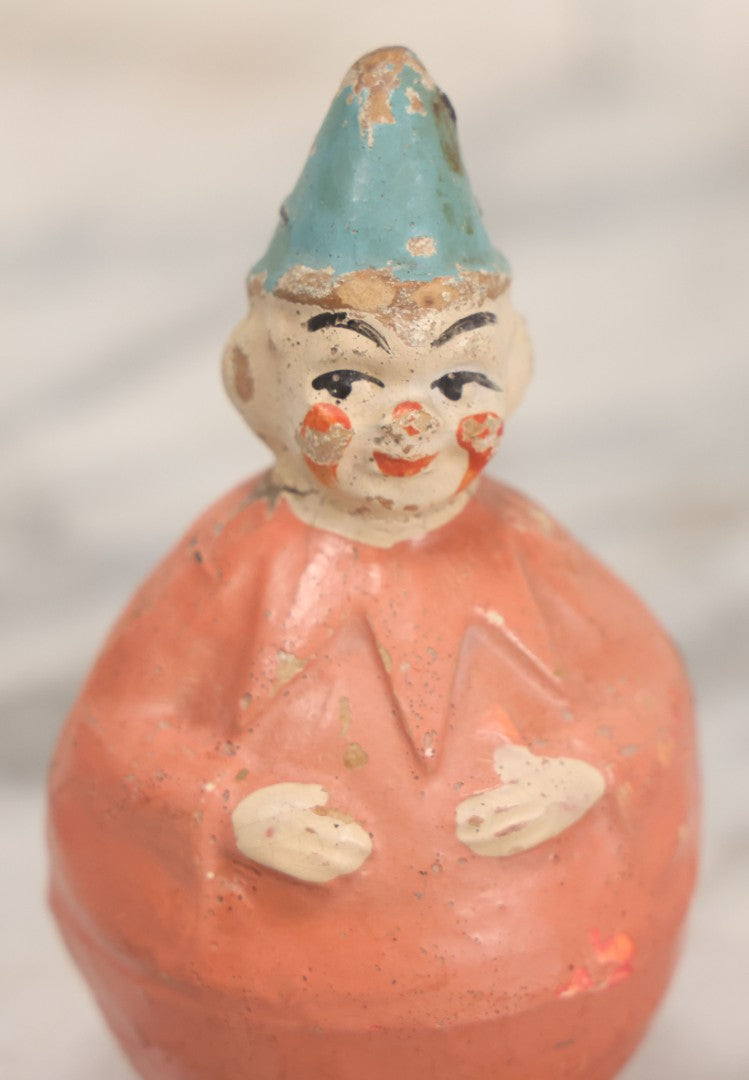 Lot 015 - Antique Papier Mache Clown Roly Poly Toy With Pink Body, Pink Makeup And Blue Hat, Note Wear And Tear Throughout, Height 3-3/4"