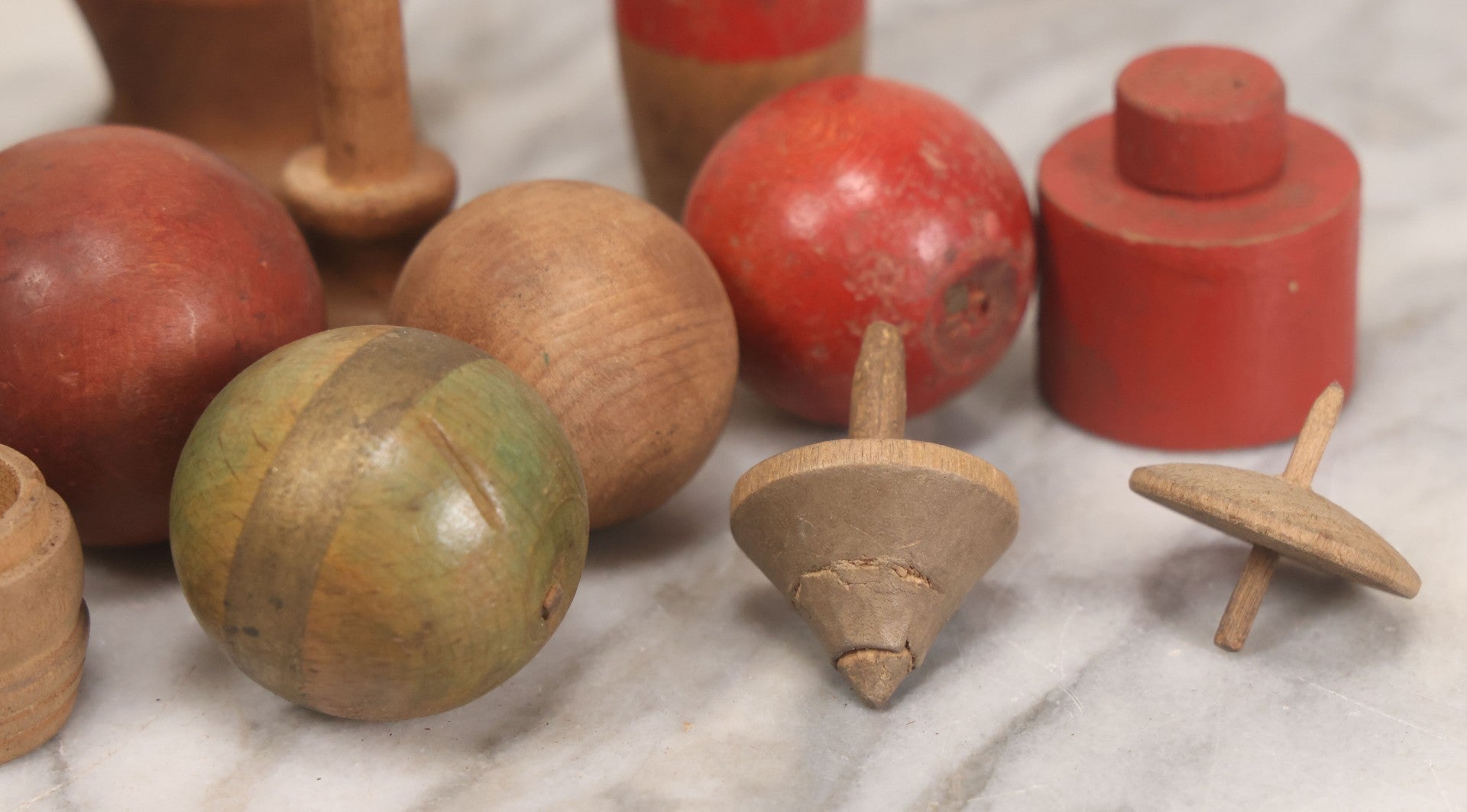Lot 035 - Miscellaneous Grouping Of Vintage And Antique Carved Wooden Toys Including Balls, Cups, Game Pieces, And Tops, 15+ Pieces