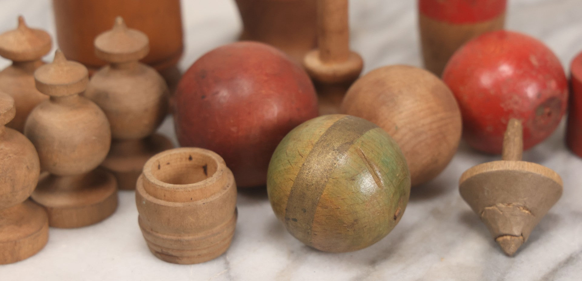 Lot 035 - Miscellaneous Grouping Of Vintage And Antique Carved Wooden Toys Including Balls, Cups, Game Pieces, And Tops, 15+ Pieces