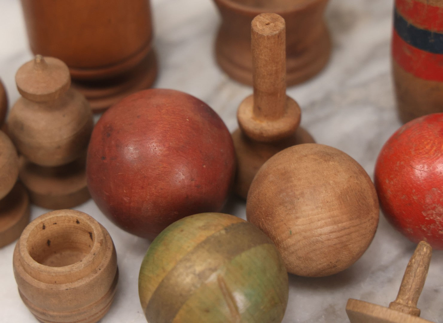 Lot 035 - Miscellaneous Grouping Of Vintage And Antique Carved Wooden Toys Including Balls, Cups, Game Pieces, And Tops, 15+ Pieces