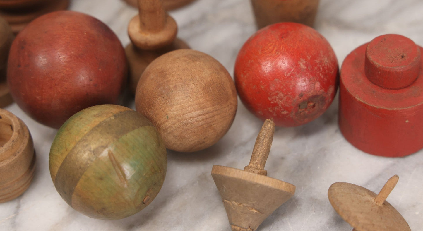 Lot 035 - Miscellaneous Grouping Of Vintage And Antique Carved Wooden Toys Including Balls, Cups, Game Pieces, And Tops, 15+ Pieces