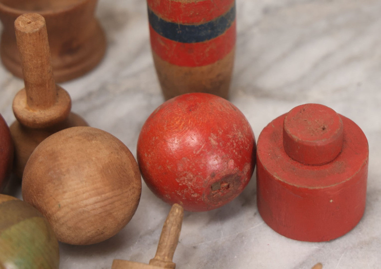 Lot 035 - Miscellaneous Grouping Of Vintage And Antique Carved Wooden Toys Including Balls, Cups, Game Pieces, And Tops, 15+ Pieces