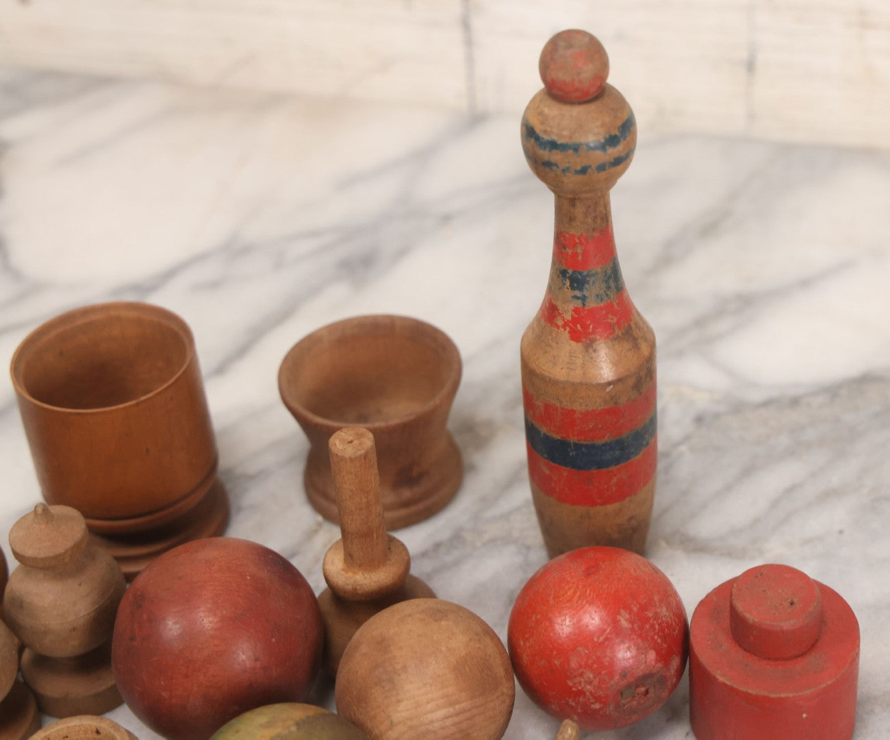Lot 035 - Miscellaneous Grouping Of Vintage And Antique Carved Wooden Toys Including Balls, Cups, Game Pieces, And Tops, 15+ Pieces