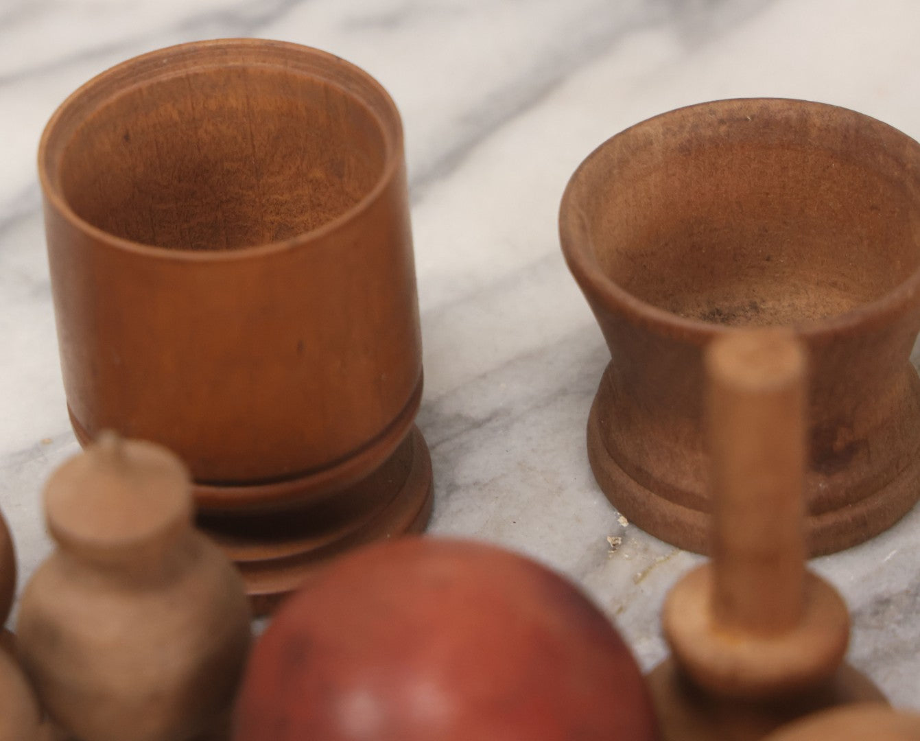 Lot 035 - Miscellaneous Grouping Of Vintage And Antique Carved Wooden Toys Including Balls, Cups, Game Pieces, And Tops, 15+ Pieces