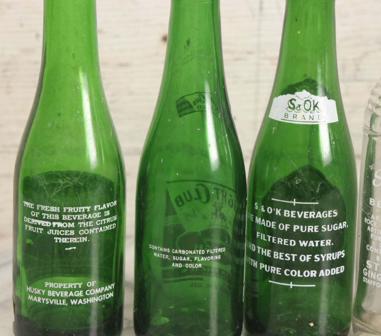 Lot 057 - Grouping Of Nine Vintage Glass Soda Bottles Including Coca-Cola, Cott, Min-R-Ize, Elk Club, Knight Club, Nugget, S&O'K, Rummy Grapefruit Drink, And Stafford Springs