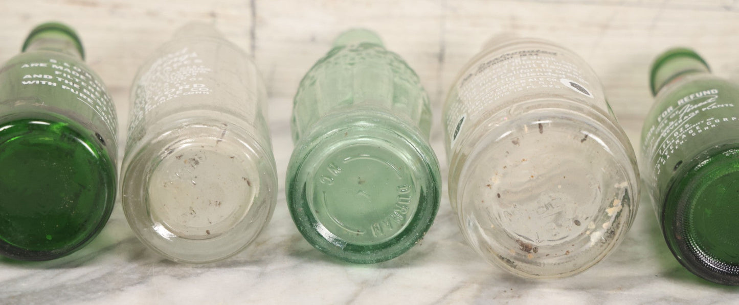 Lot 057 - Grouping Of Nine Vintage Glass Soda Bottles Including Coca-Cola, Cott, Min-R-Ize, Elk Club, Knight Club, Nugget, S&O'K, Rummy Grapefruit Drink, And Stafford Springs