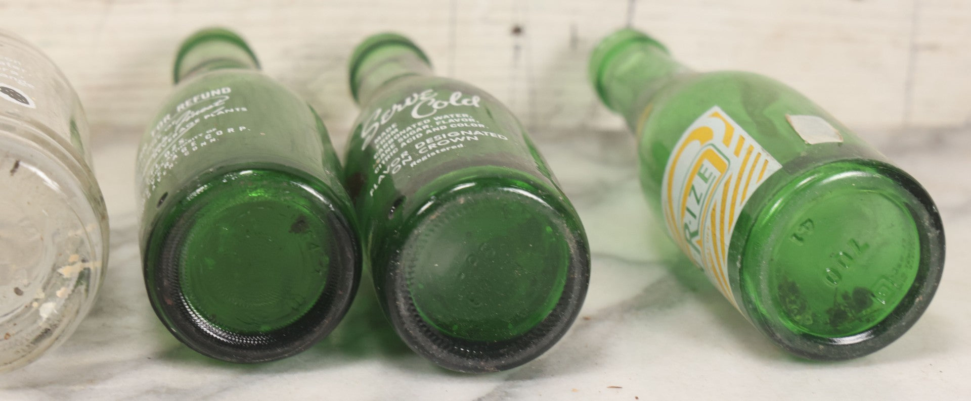 Lot 057 - Grouping Of Nine Vintage Glass Soda Bottles Including Coca-Cola, Cott, Min-R-Ize, Elk Club, Knight Club, Nugget, S&O'K, Rummy Grapefruit Drink, And Stafford Springs